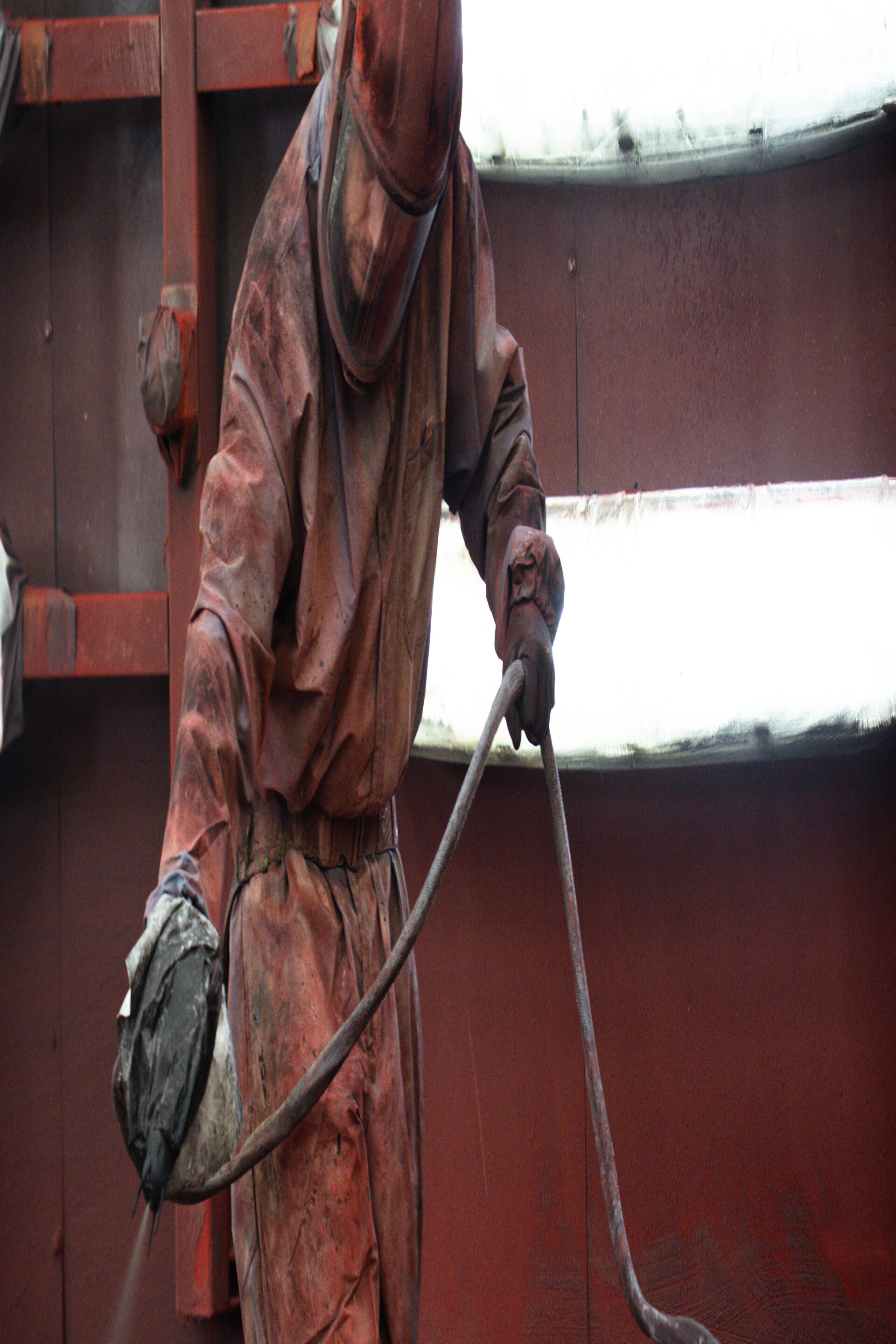 A coating specialist at Husen Stahlbau applying intumescent fire-protection coating to steel